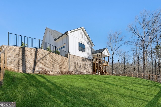 view of yard featuring stairway and fence