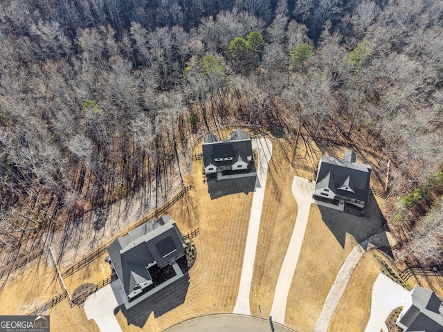 birds eye view of property featuring a view of trees