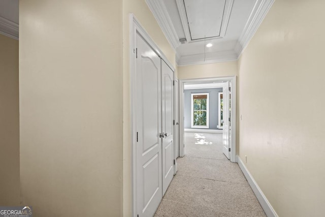 hallway featuring crown molding and light colored carpet