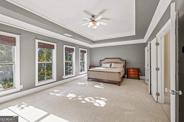 unfurnished bedroom with light carpet, a raised ceiling, ceiling fan, and ornamental molding