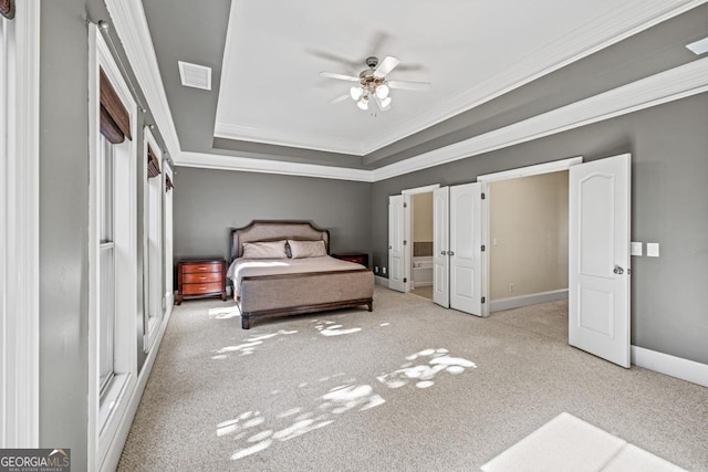 unfurnished bedroom featuring ceiling fan, a raised ceiling, ornamental molding, and light carpet