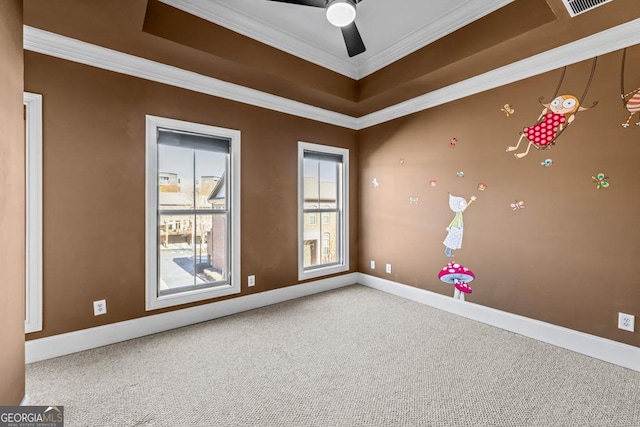 carpeted spare room featuring ceiling fan and ornamental molding