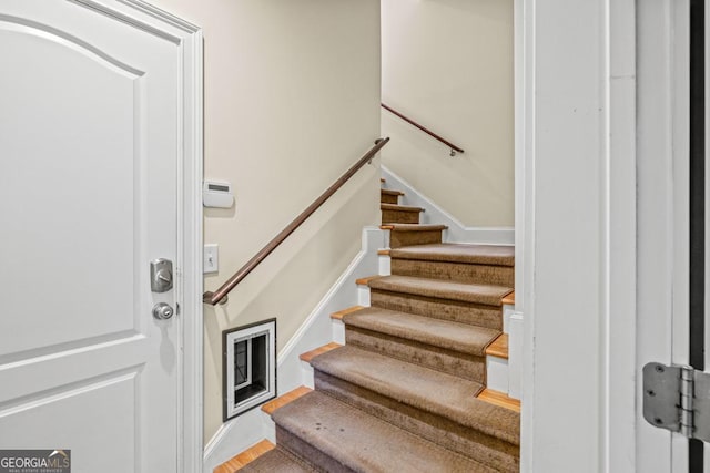 staircase with hardwood / wood-style floors