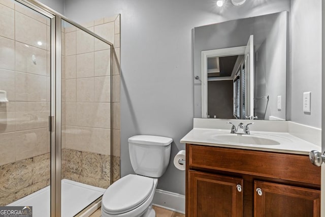 bathroom featuring walk in shower, vanity, and toilet