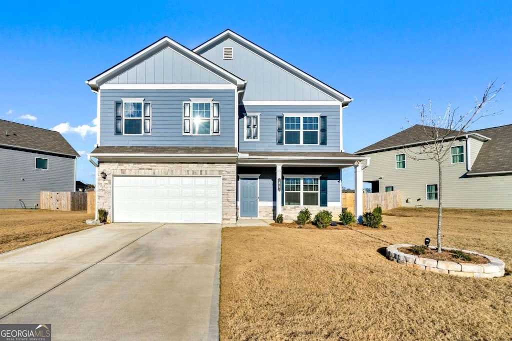 view of front of house with a garage and a front yard