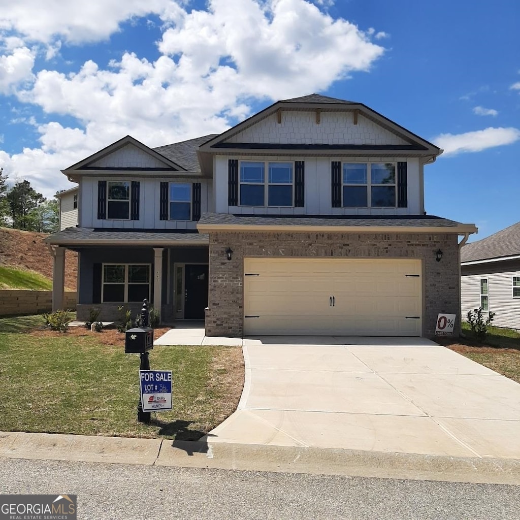 view of front of home featuring a front yard and a garage