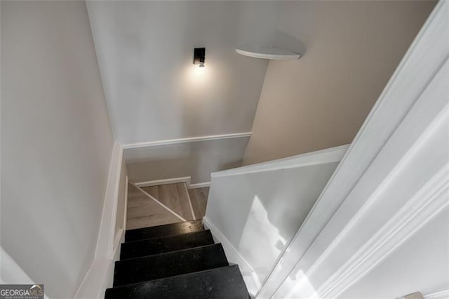 staircase featuring hardwood / wood-style floors