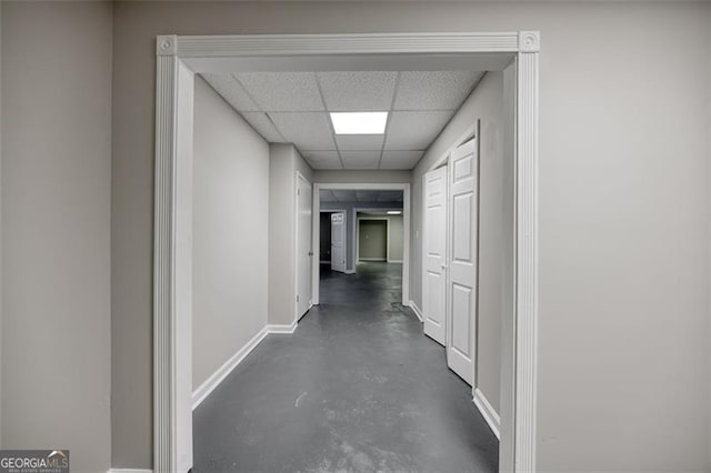 corridor with a paneled ceiling