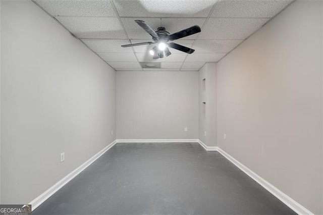 spare room featuring a drop ceiling and ceiling fan