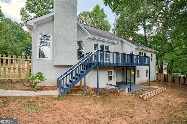 back of house featuring a patio and a wooden deck