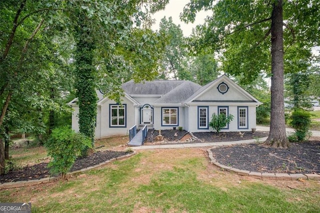 single story home featuring a front lawn