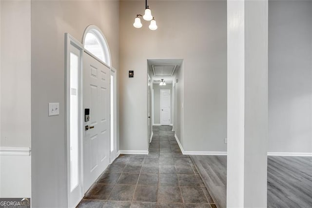 foyer with dark wood-type flooring and a high ceiling