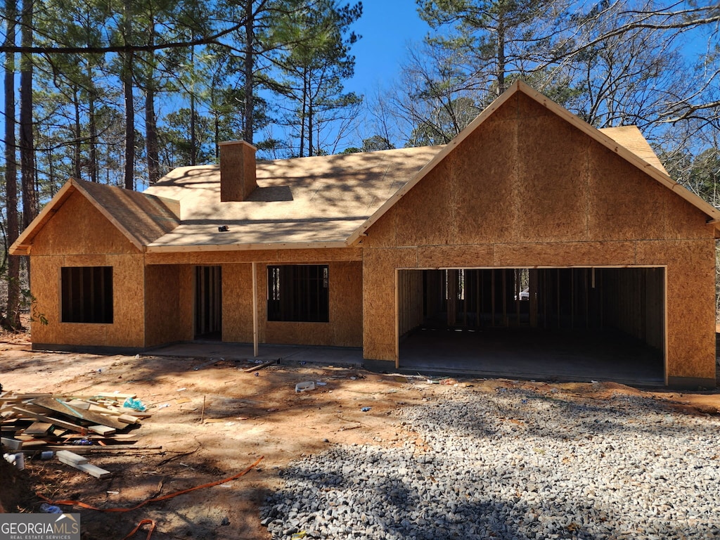 property in mid-construction with a chimney, a patio area, and stucco siding