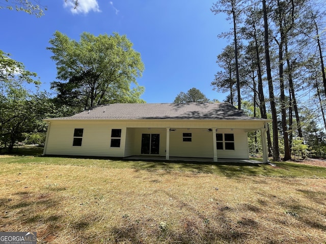 back of house featuring a yard and a patio area