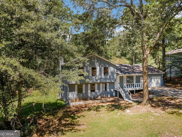 tri-level home featuring a porch and a garage