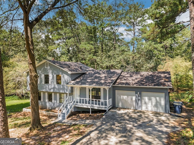 split level home featuring a porch and a garage