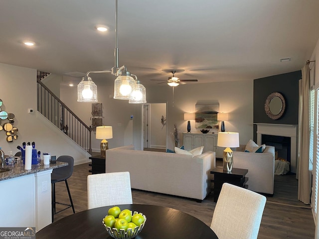 living room featuring dark hardwood / wood-style floors and ceiling fan