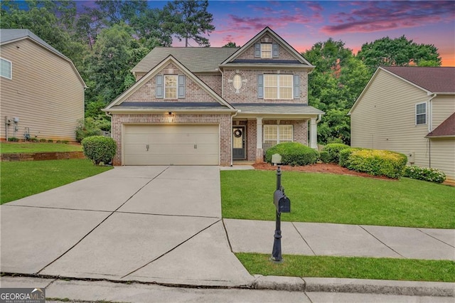 craftsman-style house featuring a lawn and a garage