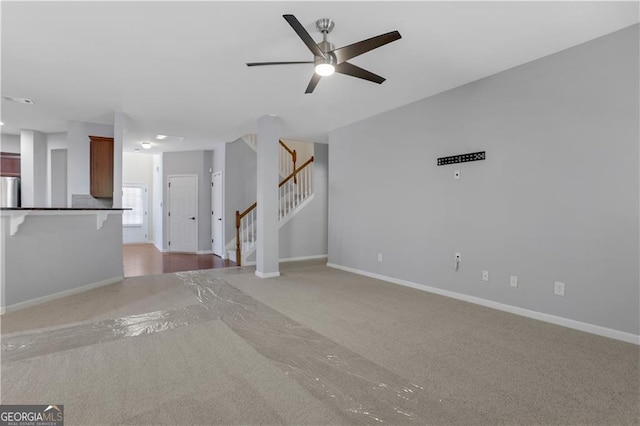 unfurnished living room featuring carpet floors and ceiling fan