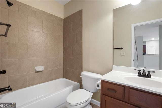 full bathroom featuring vanity, tiled shower / bath combo, and toilet