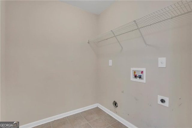 laundry area with gas dryer hookup, light tile patterned floors, washer hookup, and hookup for an electric dryer