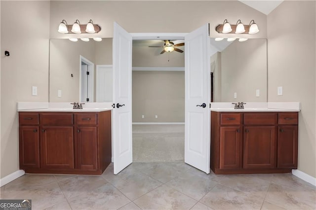 bathroom with tile patterned flooring, ceiling fan, vanity, and vaulted ceiling