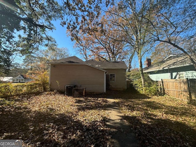 rear view of property featuring central air condition unit