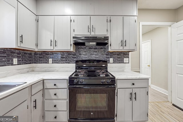 kitchen with decorative backsplash, black gas range, light hardwood / wood-style floors, and white cabinetry