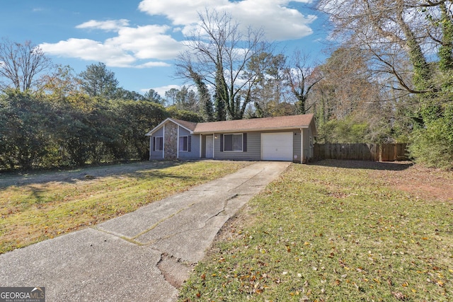 ranch-style house featuring a garage and a front lawn