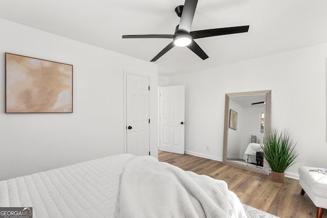 bedroom with hardwood / wood-style floors and ceiling fan