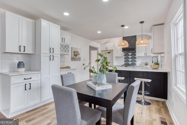 dining space with light hardwood / wood-style floors