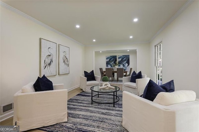 living area featuring ornamental molding, recessed lighting, visible vents, and wood finished floors