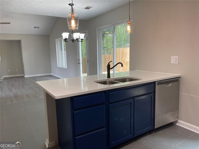 kitchen featuring vaulted ceiling, stainless steel dishwasher, blue cabinets, and sink