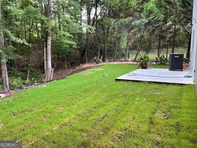 view of yard featuring central AC unit and a patio area