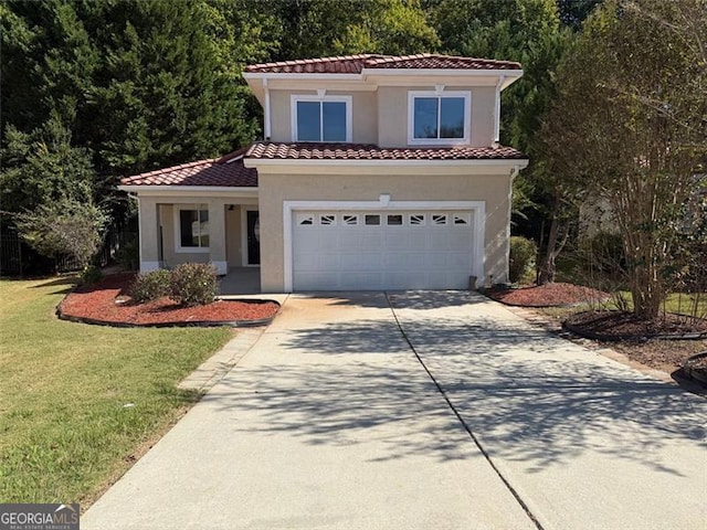 mediterranean / spanish house featuring a front yard and a garage