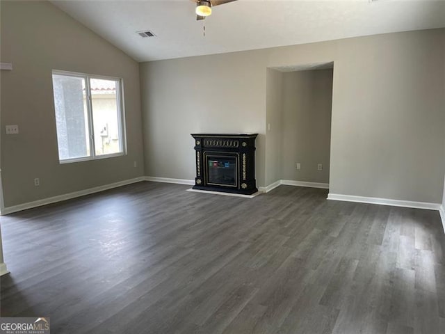 unfurnished living room with dark hardwood / wood-style floors and vaulted ceiling