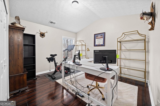 home office featuring a textured ceiling, lofted ceiling, and dark hardwood / wood-style floors