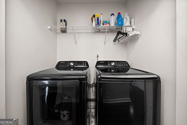 clothes washing area featuring independent washer and dryer