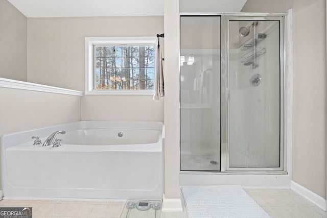 bathroom featuring tile patterned floors and separate shower and tub