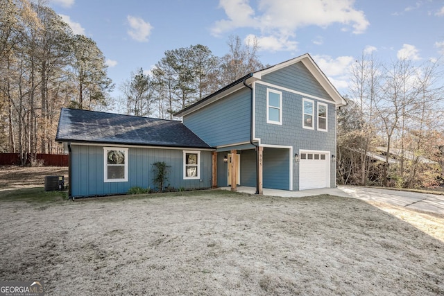 view of property with a garage and central air condition unit