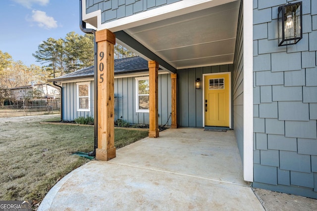 entrance to property featuring a lawn