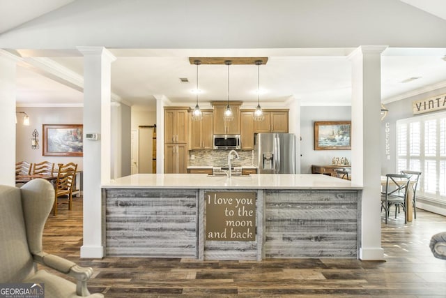 104 Red Fox Run, Dublin, GA 31021 - kitchen with appliances with stainless steel finishes, dark wood-style floors, a peninsula, crown molding, and tasteful backsplash