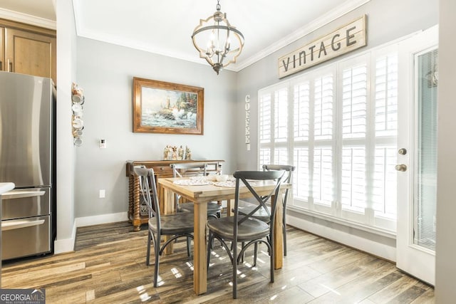 104 Red Fox Run, Dublin, GA 31021 - dining area featuring a chandelier, baseboards, crown molding, and wood finished floors