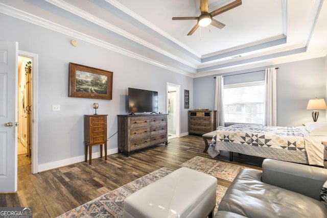 bedroom featuring dark wood-type flooring, a tray ceiling, baseboards, ornamental molding, and a ceiling fan