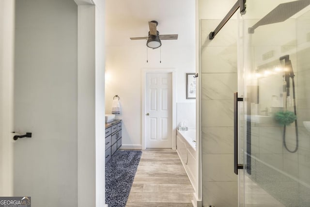 bathroom with ceiling fan, vanity, shower with separate bathtub, and hardwood / wood-style flooring