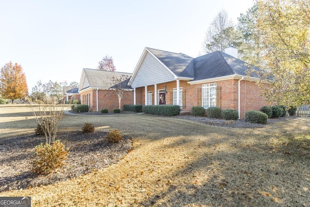 view of side of property with a lawn