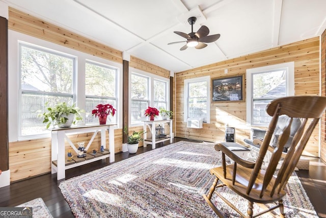 sunroom featuring ceiling fan, a healthy amount of sunlight, and vaulted ceiling