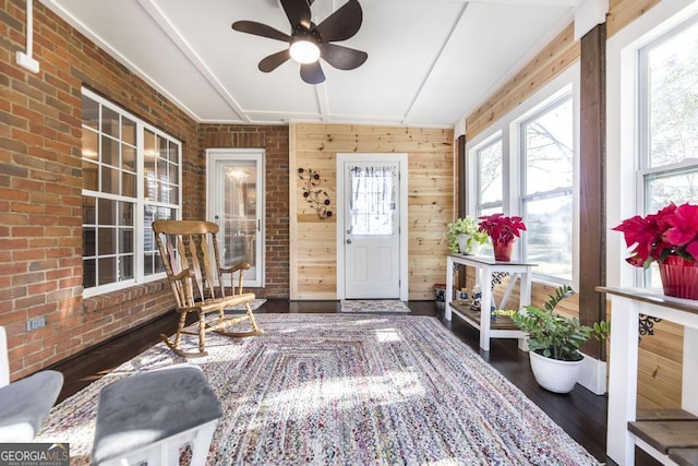 sunroom featuring ceiling fan