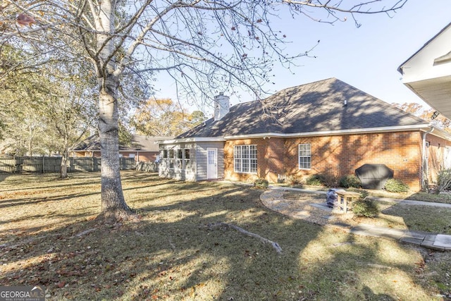 back of house with a lawn