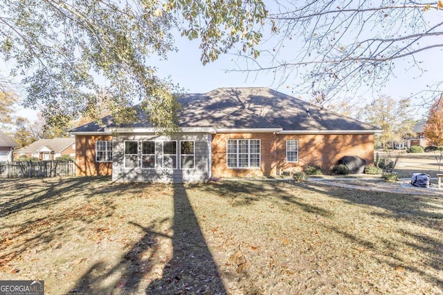 back of house featuring a lawn